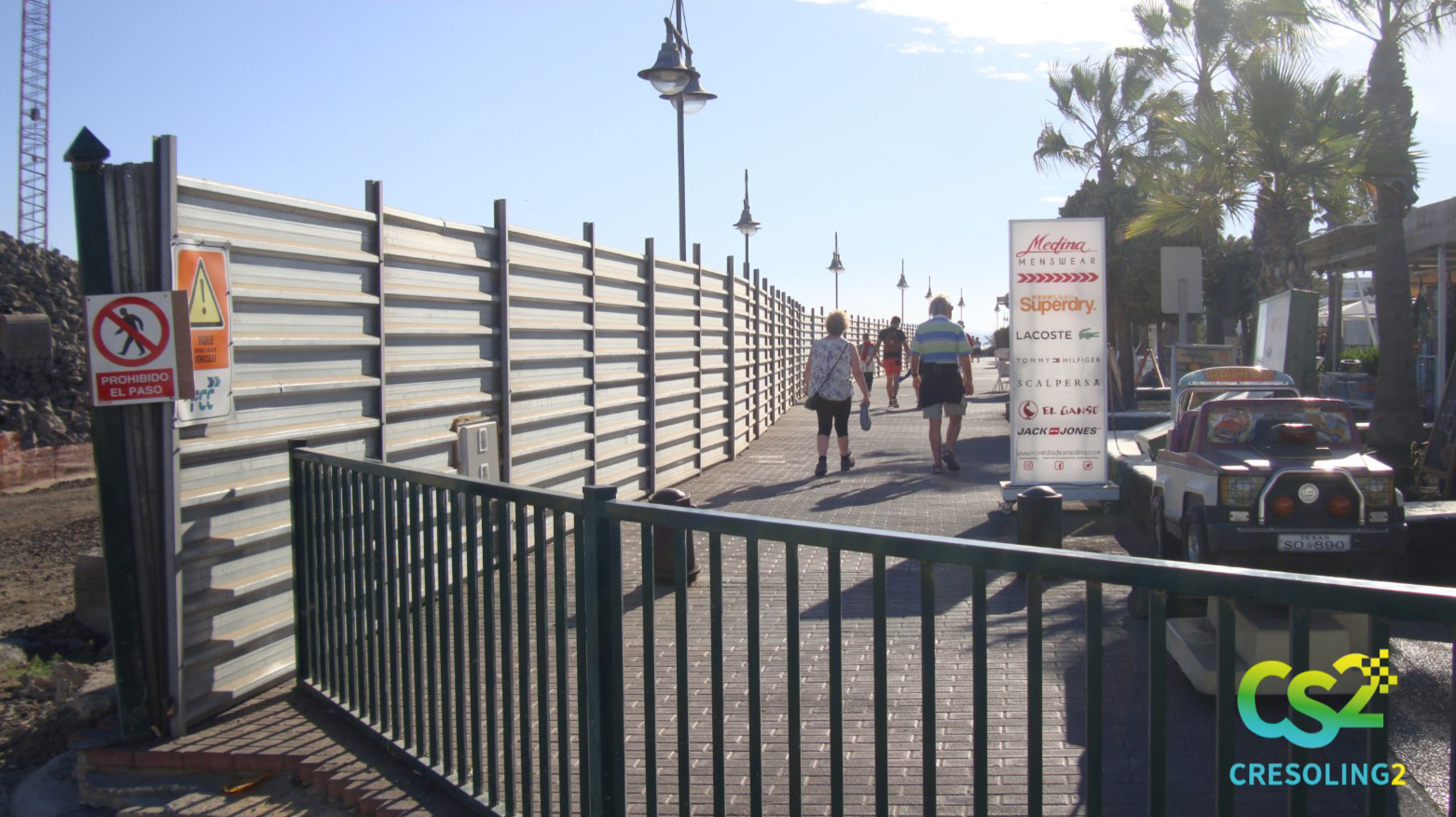 The barrier set up along the perimeter of the worksite acts as an acoustic buffer