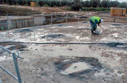 Worker collecting the material after making the boreholes